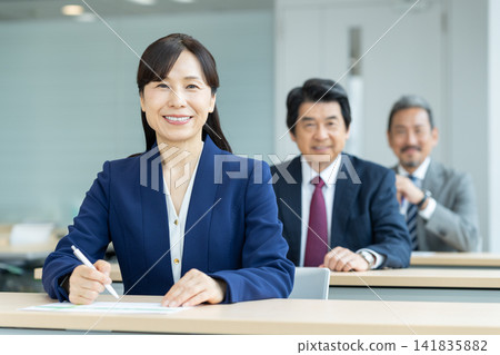 A middle-aged businesswoman undergoing training. Filming assistance provided by: Denpa Gakuen Educational Foundation, Tokyo Electronics College. A middle-aged businesswoman undergoing training. Filming assistance provided by: Denpa Gakuen Educational Foundation, Tokyo Electronics College. 141835882