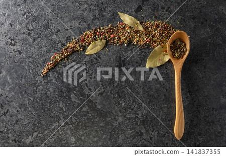 Mix of organic dried spices on a black stone background. Mix of organic dried spices on a black stone background. 141837355