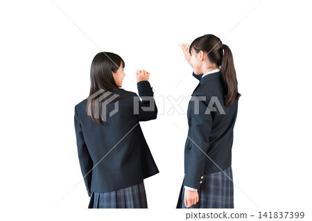 A female junior high school student writing with chalk on a blackboard in the classroom A female junior high school student writing with chalk on a blackboard in the classroom 141837399