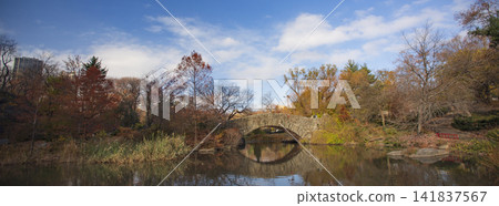Autumn Gapstow Bridge under blue cloudy sky in Central Park, wide panoramic New York City view with copy space Autumn Gapstow Bridge under blue cloudy sky in Central Park, wide panoramic New York City view with copy space 141837567