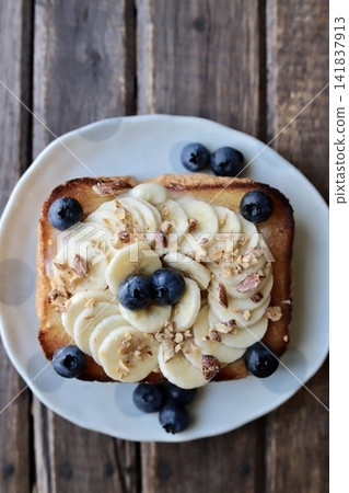 Banana, blueberry, and candied nut toast variation 141837913