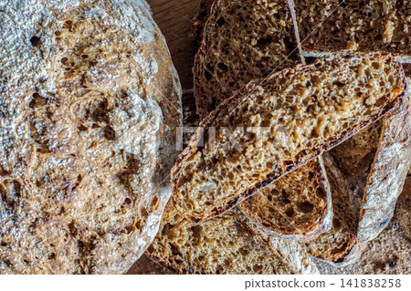 Close up of rustic seeded artisan bread loaf with sliced whole grain crumb. Homemade bakery bread texture. Close up of rustic seeded artisan bread loaf with sliced whole grain crumb. Homemade bakery bread texture. 141838258