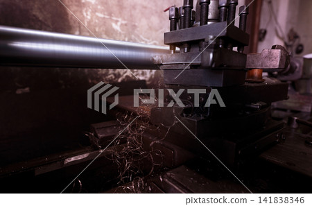 Lathe machine working in factory. Lathe turning machine for metalwork. Heavy machinery manufacturing. Machine for milling metal. Manual lathe machine. Safety in industrial workplace. Steel industry. Lathe machine working in factory. Lathe turning machine for metalwork. Heavy machinery manufacturing. Machine for milling metal. Manual lathe machine. Safety in industrial workplace. Steel industry. 141838346
