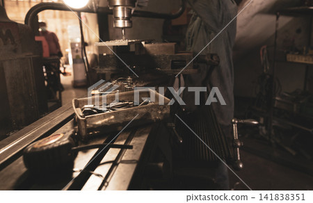 Tools in plastic box on blur milling machine and worker in workshop. Worker working with milling machine. Tool for drill and cut metal workpiece. Steel manufacturing industry. Milling process. Tools in plastic box on blur milling machine and worker in workshop. Worker working with milling machine. Tool for drill and cut metal workpiece. Steel manufacturing industry. Milling process. 141838351