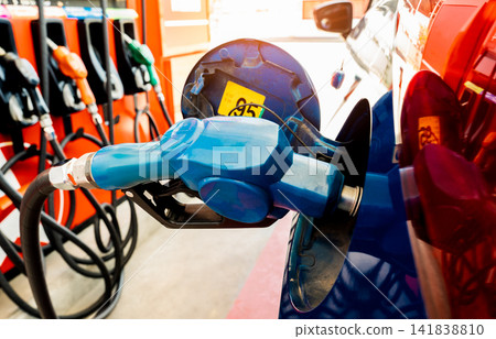 Car fueling at gas station. Refuel fill up with petrol gasoline. Petrol pump filling fuel nozzle in fuel tank of car at gas station. Petrol industry and service. Petrol price and oil crisis concept. Car fueling at gas station. Refuel fill up with petrol gasoline. Petrol pump filling fuel nozzle in fuel tank of car at gas station. Petrol industry and service. Petrol price and oil crisis concept. 141838810