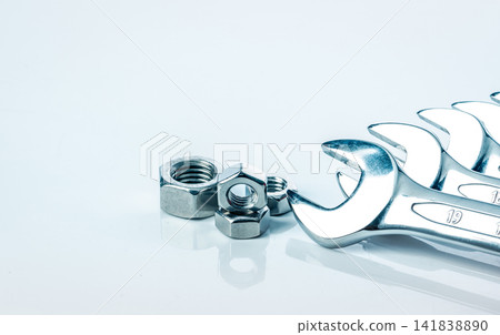 Metal hexagon nuts and chrome wrenches isolated on white background. Mechanic tools for maintenance. Hardware tool. Fastener with a threaded hole. Set chrome spanner wrench and nuts. Silver wrenches. Metal hexagon nuts and chrome wrenches isolated on white background. Mechanic tools for maintenance. Hardware tool. Fastener with a threaded hole. Set chrome spanner wrench and nuts. Silver wrenches. 141838890