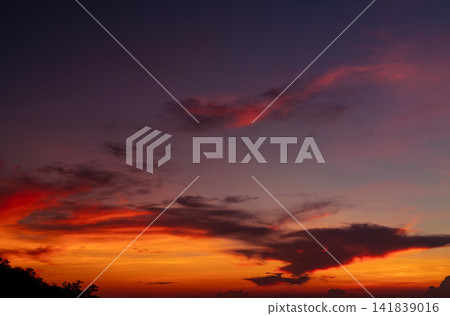 Colorful twilight sky featuring glowing sunset clouds with warm orange, crimson and deep blue gradients, capturing a dramatic evening atmosphere, scenic cloudscape and panoramic nature background. Colorful twilight sky featuring glowing sunset clouds with warm orange, crimson and deep blue gradients, capturing a dramatic evening atmosphere, scenic cloudscape and panoramic nature background. 141839016