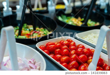 Salad bar buffet at restaurant. Fresh salad bar buffet for lunch or dinner. Healthy food. Selective focus on red tomatoes in white bowl on counter. Catering food. Banquet service. Vegetarian food. Salad bar buffet at restaurant. Fresh salad bar buffet for lunch or dinner. Healthy food. Selective focus on red tomatoes in white bowl on counter. Catering food. Banquet service. Vegetarian food. 141839063