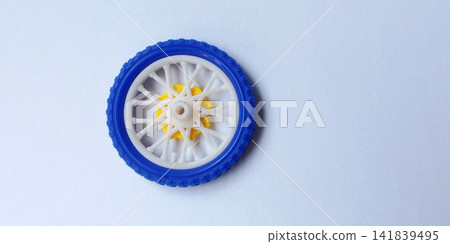Colorful plastic toy bicycle wheels isolated on a white background. Colorful plastic toy bicycle wheels isolated on a white background. 141839495