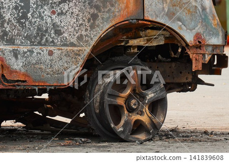 Melted Exploded Car Tire and Charred Wheel Rim Detail Melted Exploded Car Tire and Charred Wheel Rim Detail 141839608