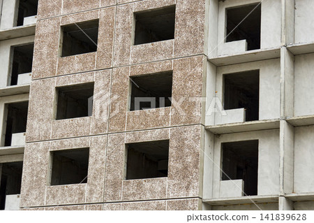 Focused view of raw concrete architectural elements. Close examination of unfinished concrete surface with panel details and textures Focused view of raw concrete architectural elements. Close examination of unfinished concrete surface with panel details and textures 141839628
