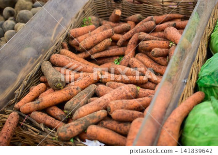 Organic Unwashed Carrots in a Wicker Basket Market Display Organic Unwashed Carrots in a Wicker Basket Market Display 141839642