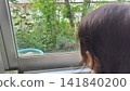 Child looking out the window Child looking out the window 141840200