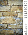 Close up view of a beige stone wall with beautiful masonry details, showing a natural architectural texture and traditional construction material. 141840392