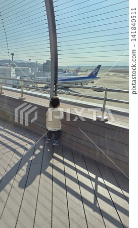 Children watching airplanes at the airport Children watching airplanes at the airport 141840511