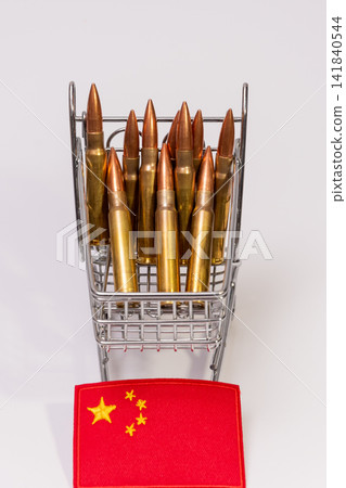 Shopping cart filled with rifle cartridges beside Chinese flag on white background Shopping cart filled with rifle cartridges beside Chinese flag on white background 141840544