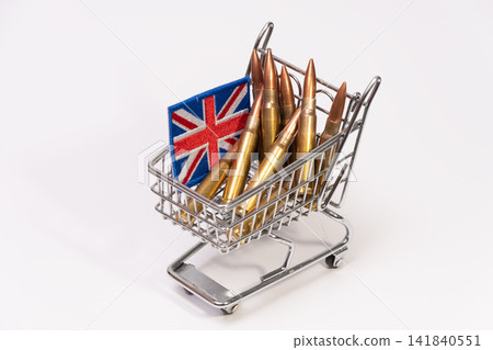 Mini shopping cart filled with rifle cartridges and British flag patch 141840551