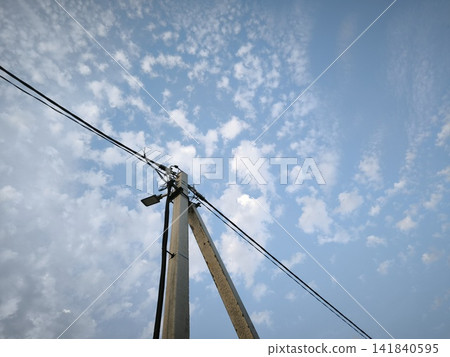 Concrete power transmission tower with wires stretched out against the sky Concrete power transmission tower with wires stretched out against the sky 141840595