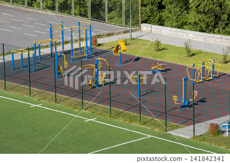 Urban outdoor sports ground with weight training equipment for sports. Sports and recreation area, top view. Urban outdoor sports ground with weight training equipment for sports. Sports and recreation area, top view. 141842341