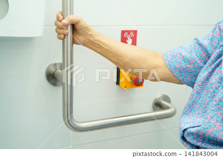 Asian elderly woman press emergency button in toilet. Asian elderly woman press emergency button in toilet. 141843004