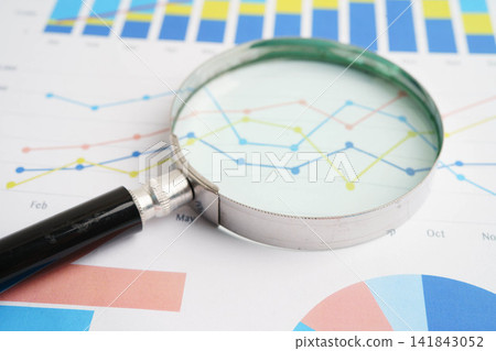 Magnifying glass on charts graphs paper. Financial development, Banking Account, Statistics, Investment Analytic research data economy. 141843052