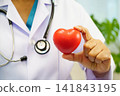 Asian woman doctor holding red heart for health in hospital. 141843195