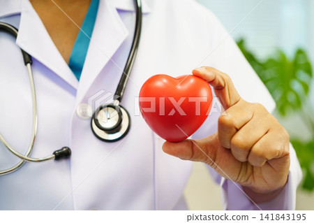 Asian woman doctor holding red heart for health in hospital. Asian woman doctor holding red heart for health in hospital. 141843195
