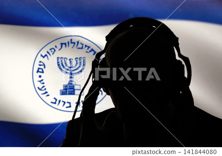 Secret agent of the Israeli intelligence eavesdropping on conversations, spy and special agent, the Israeli flag of the special services. Hebrew inscription, image of the menorah. Secret agent of the Israeli intelligence eavesdropping on conversations, spy and special agent, the Israeli flag of the special services. Hebrew inscription, image of the menorah. 141844080