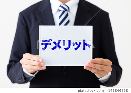 A young businessman in a business suit holding a whiteboard (a disadvantage of the whiteboard) A young businessman in a business suit holding a whiteboard (a disadvantage of the whiteboard) 141844518