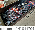 Top angle view of hot charcoal burning with intense heat inside metal barbecue mangal grill ready for outdoor summer picnic cooking and meat grilling 141844704