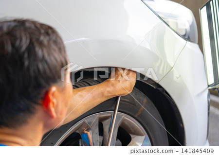 Removing dents on the car. PDR technology. Car body repair without painting. Removing dents on the car. PDR technology. Car body repair without painting. 141845409