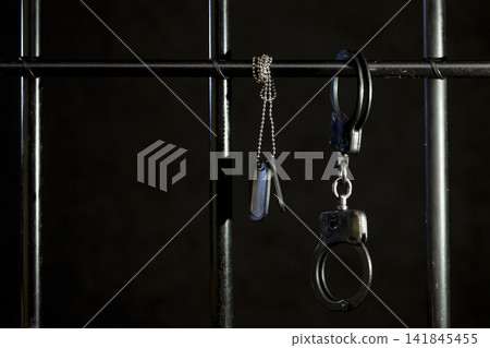 Gloomy composition with symbols of law - judge's gavel and prison elements Gloomy composition with symbols of law - judge's gavel and prison elements 141845455