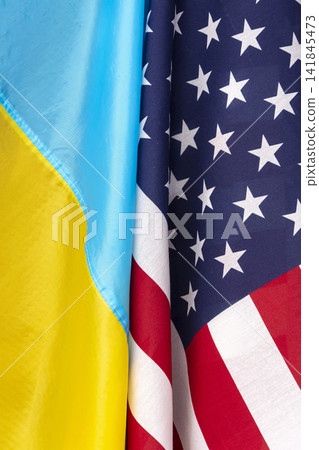 The flag of Ukraine and the flag of America are connected together, close-up, curves and waves on the flags. Concept: joint meeting, Lend-Lease assistance. The flag of Ukraine and the flag of America are connected together, close-up, curves and waves on the flags. Concept: joint meeting, Lend-Lease assistance. 141845473