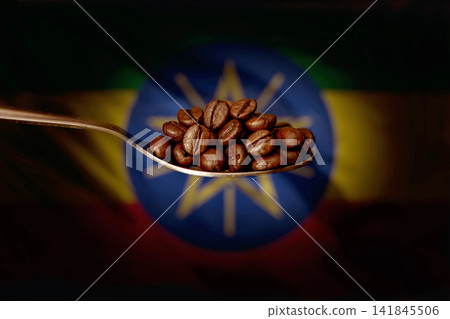 A spoon filled with roasted coffee beans on the background of the flag of Ethiopia. Concept: export and import of Ethiopian coffee beans, delivery of goods. A spoon filled with roasted coffee beans on the background of the flag of Ethiopia. Concept: export and import of Ethiopian coffee beans, delivery of goods. 141845506