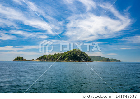 Tomogashima Island, floating in the blue sea and sky of the Kitan Strait. Tomogashima Island, floating in the blue sea and sky of the Kitan Strait. 141845538