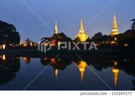 pagoda of Wat Phra Si Sanphet or temple of the holy, splendid Omniscient reflection on water with electric lamp in night pagoda of Wat Phra Si Sanphet or temple of the holy, splendid Omniscient reflection on water with electric lamp in night 141845577