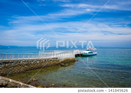 The Tomogashima Ferry docked at Nonoura Pier on Tomogashima Island, and the blue sea. The Tomogashima Ferry docked at Nonoura Pier on Tomogashima Island, and the blue sea. 141845626