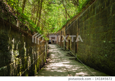 The brick fortress ruins and sunlight filtering through the trees at the site of the Third Battery on Tomogashima Island 141845672