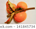 Persimmons harvested with the branches still attached. 141845734