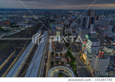 An aerial view of the city center at twilight, with light trails remaining in the station square in front of Koriyama Station's west exit [Koriyama Station, Fukushima Prefecture] 141845740