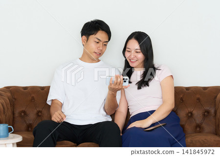 Young men and women using smartphones Young men and women using smartphones 141845972