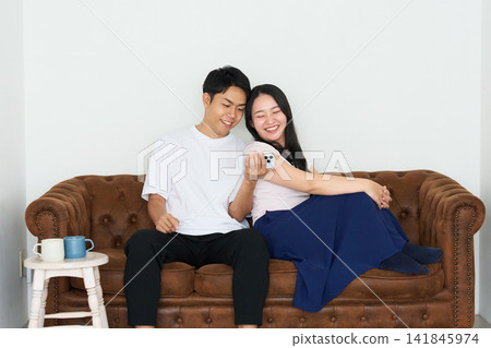 Young men and women using smartphones Young men and women using smartphones 141845974