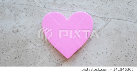 Fabric pink heart on the stone table background. Concept with love sign for card and Valentines day. Fabric pink heart on the stone table background. Concept with love sign for card and Valentines day. 141846305
