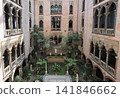The Isabella Stewart Gardner Museum courtyard is a stunning, four-story glass-covered Venetian palazzo garden featuring antique marble sculptures, ancient architectural fragments, and vibrant monthly  141846662