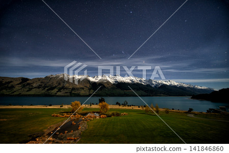 Starry Night Sky Over Snowy Mountains and Lake Landscape Starry Night Sky Over Snowy Mountains and Lake Landscape 141846860