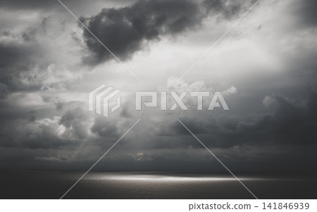 Storm Clouds Over Dark Ocean Horizon in Moody Monochrome Storm Clouds Over Dark Ocean Horizon in Moody Monochrome 141846939