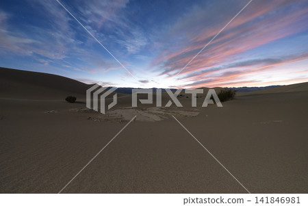 Desert Dunes at Twilight Under Colorful Cloudy Sky Desert Dunes at Twilight Under Colorful Cloudy Sky 141846981