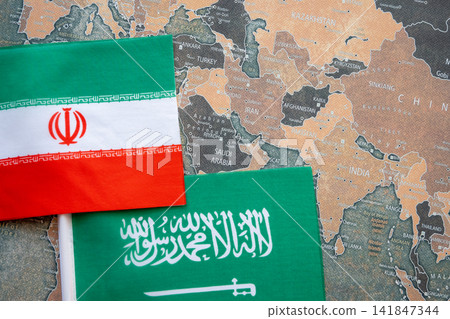 National flag of Iran and Saudi Arabia on the world map background. Iran and USA conflict and crisis. National flag of Iran and Saudi Arabia on the world map background. Iran and USA conflict and crisis. 141847344