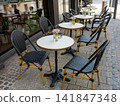 Cafe on the open air in Luxemburg. Chairs and tables outside with summer sun weather in Luxemburg city on the street. Design of furnitureset for summer cafe or restaurant. 141847348