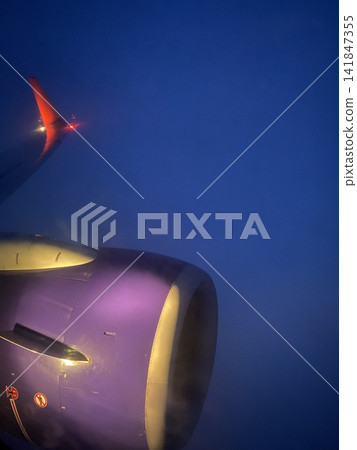 Airplane Engine Above the Clouds at Dawn Airplane Engine Above the Clouds at Dawn 141847355